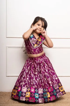 Elegant purple lehenga set with intricate golden floral motifs and multicolored patchwork accents for a festive look